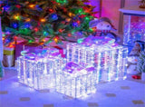3 glowing Christmas gift boxes with bows 04567105
