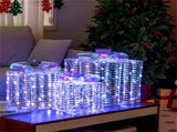 3 glowing Christmas gift boxes with bows 04567105
