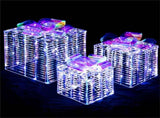 3 glowing Christmas gift boxes with bows 04567105